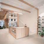 EDGAR Bordeaux menswear store interior with wooden counter and sneaker display wall