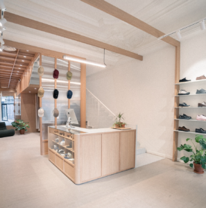 EDGAR Bordeaux menswear store interior with wooden counter and sneaker display wall