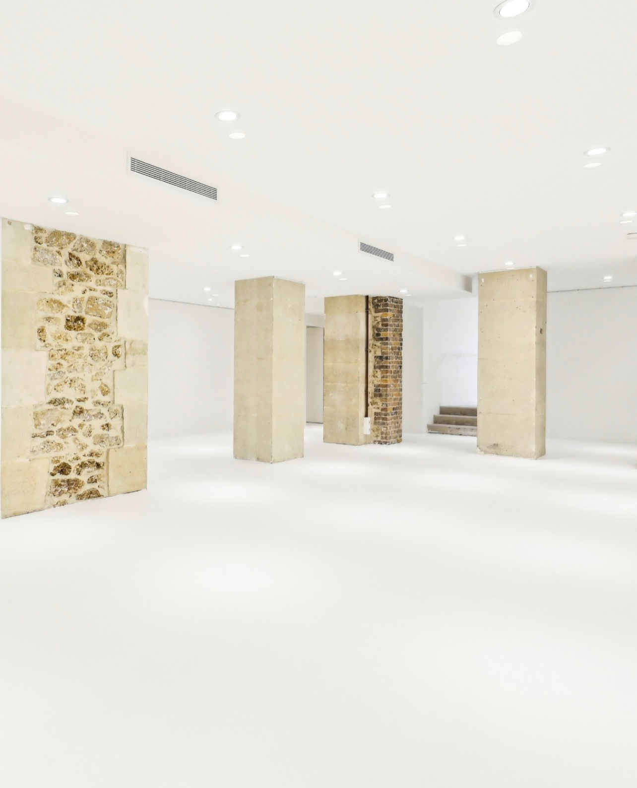 paris-basement-gallery-stone-pillars-white-space