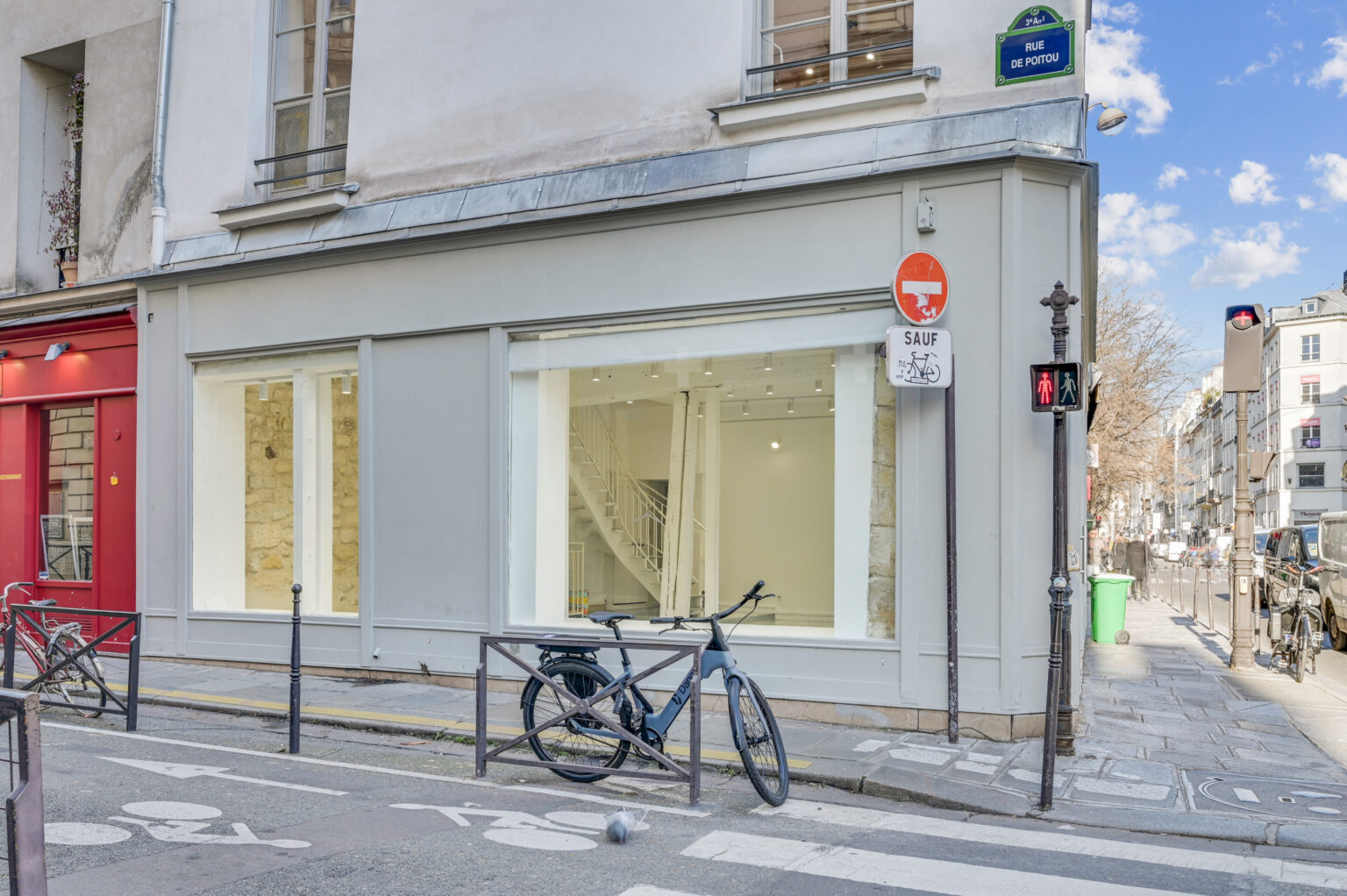 Corner facade with wraparound storefront windows at 97 Rue de Turenne, Le Marais, Paris
