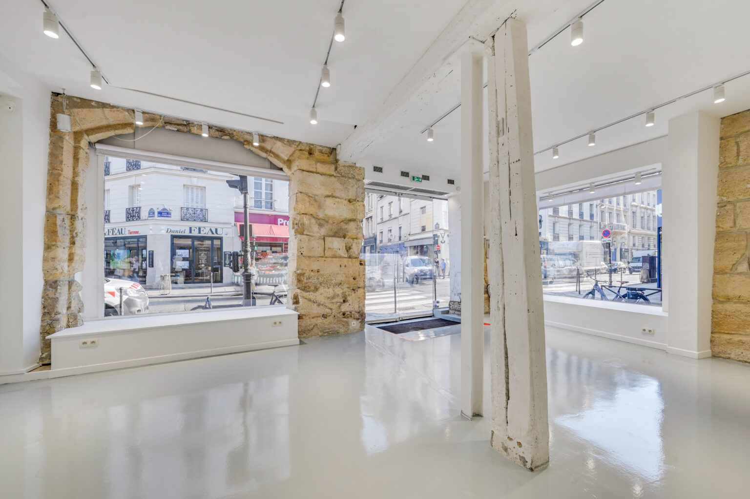 Ground floor showroom view toward the corner windows and entrance at 97 Rue de Turenne, Le Marais