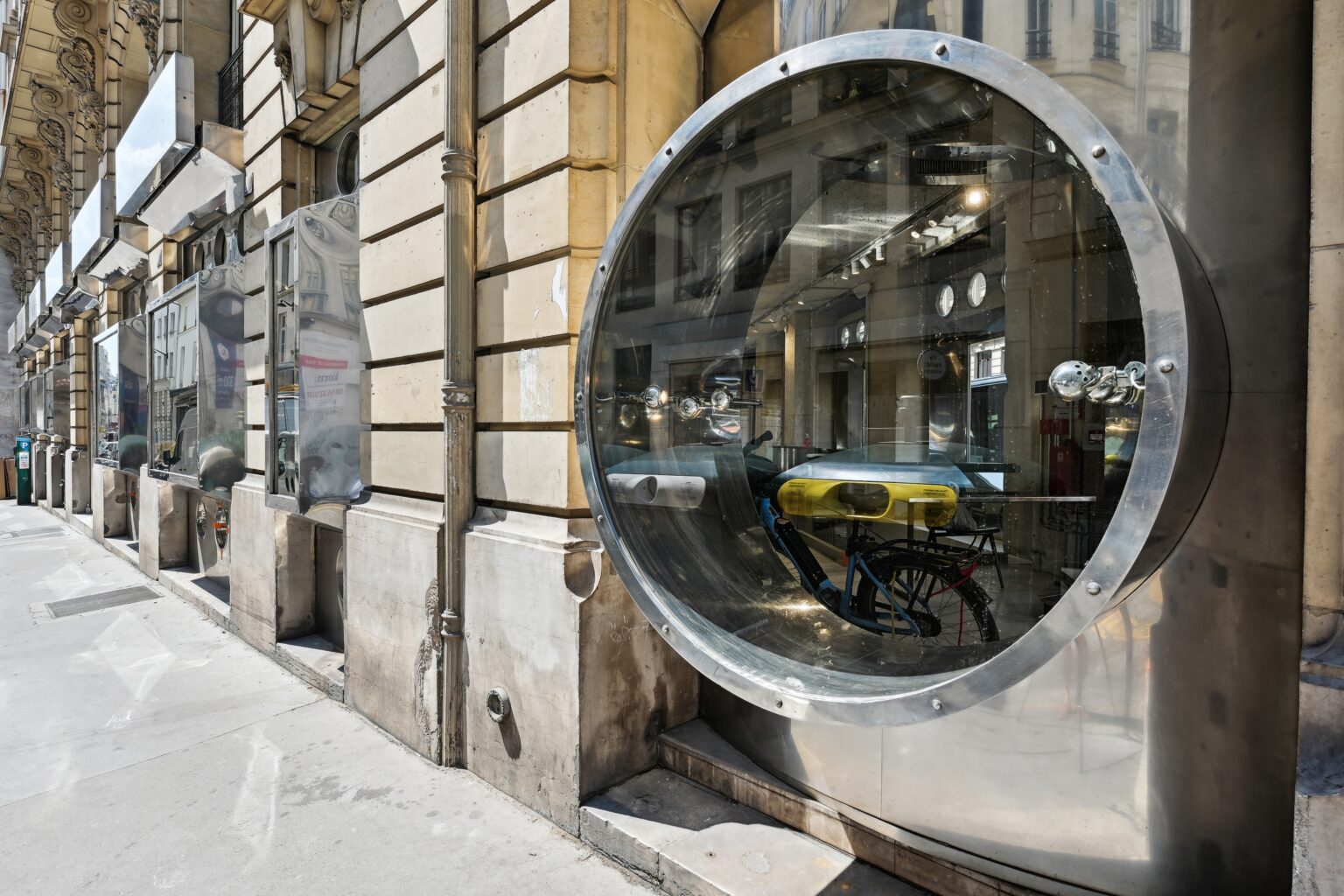 Circular display window detail on Espace Réaumur facade with metal surround