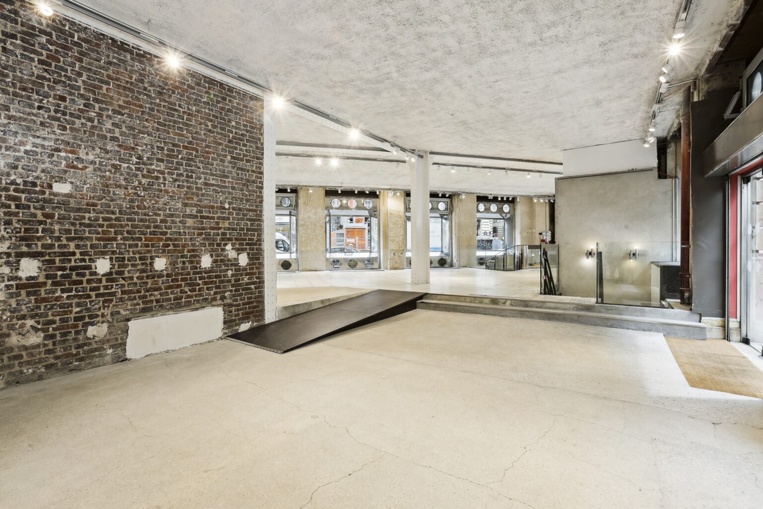 Overhead view of the metal spiral staircase inside Espace Reaumur leading to the lower level