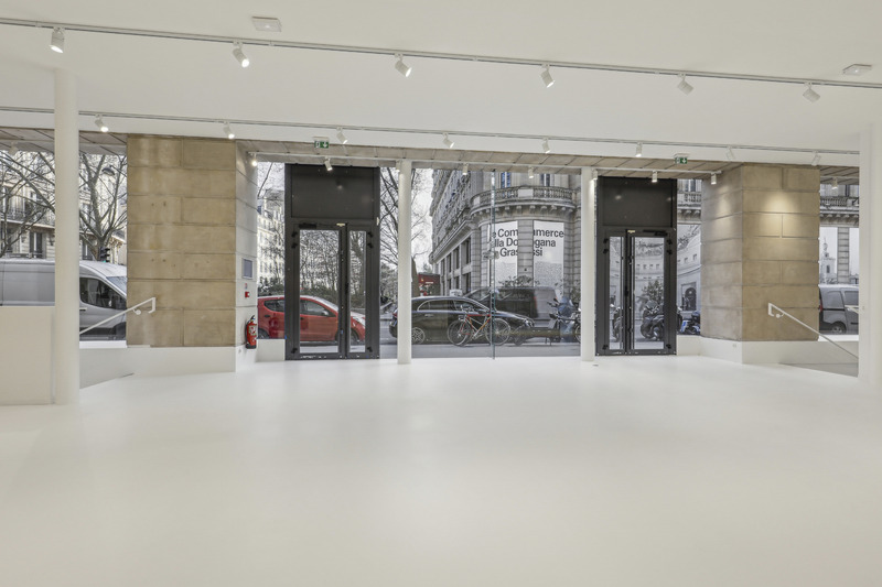 Interior frontal view of two entrance doors and large glass windows facing the street.