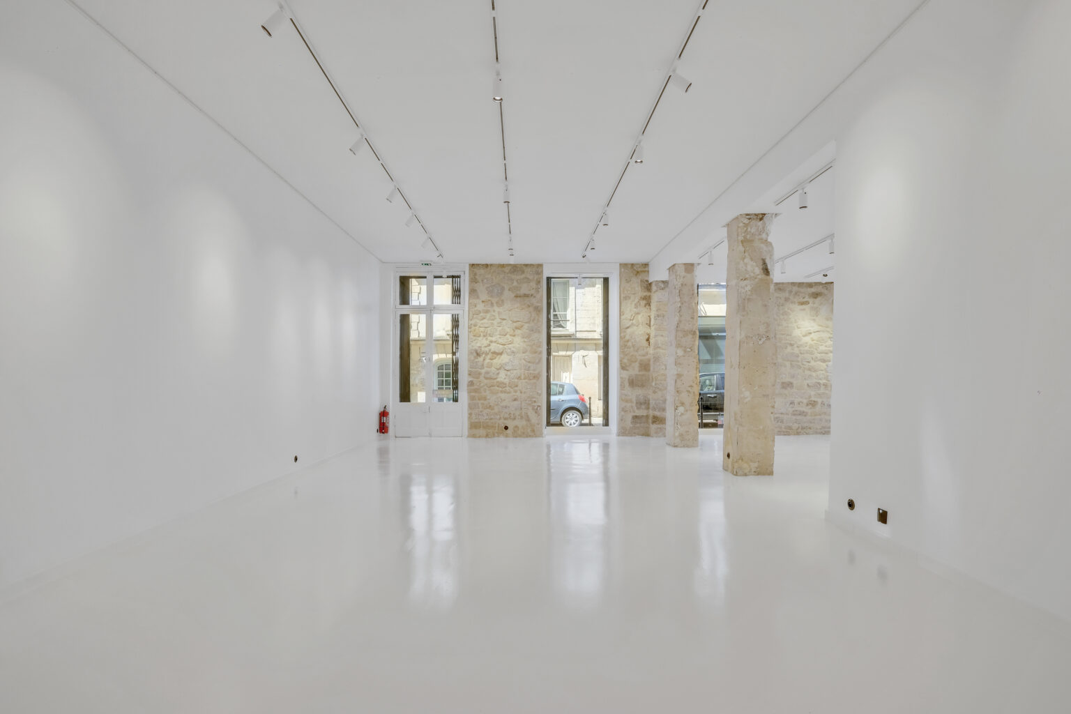 Secondary room looking toward windows in the 62 Rue Charlot showroom
