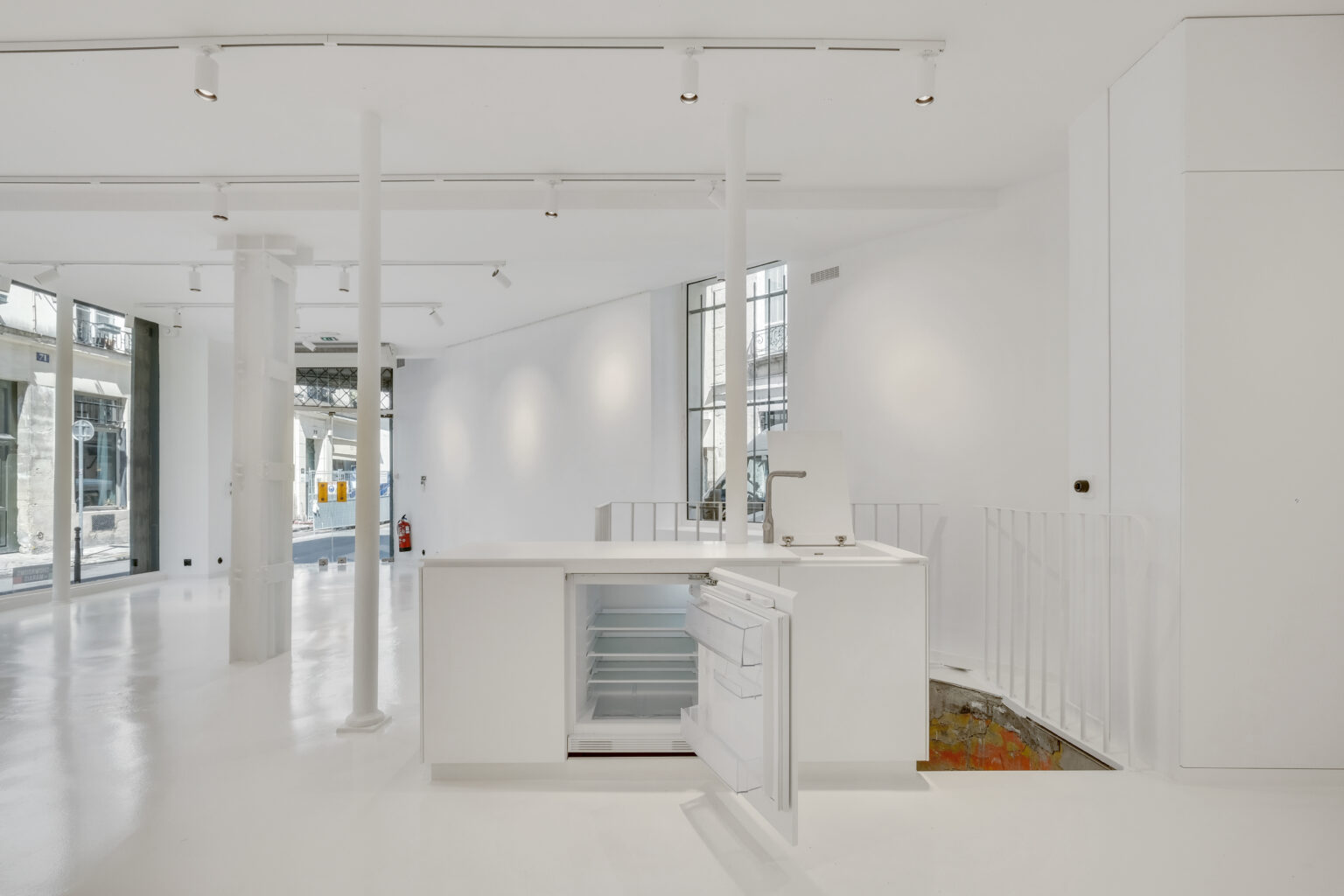 White counter and bar area inside 62 Rue Charlot showroom, Paris