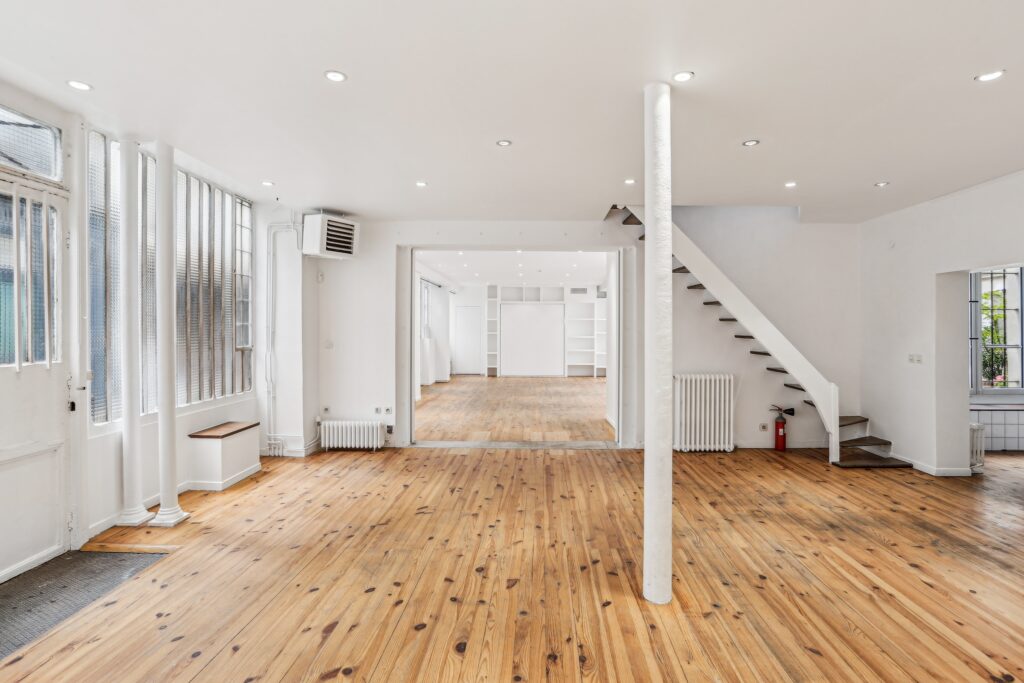 Ground floor showroom with staircase and open layout.