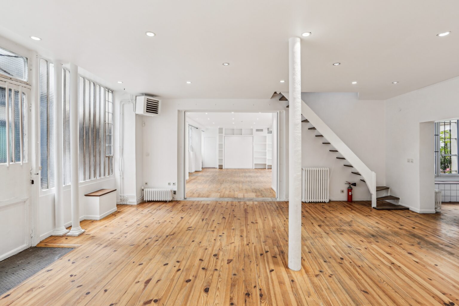 Ground floor showroom with staircase and open layout.