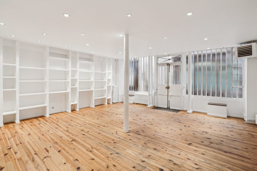 Ground floor wall shelving within showroom space.
