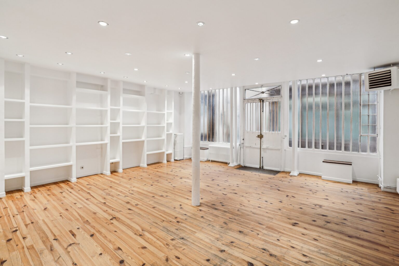 Ground floor wall shelving within showroom space.