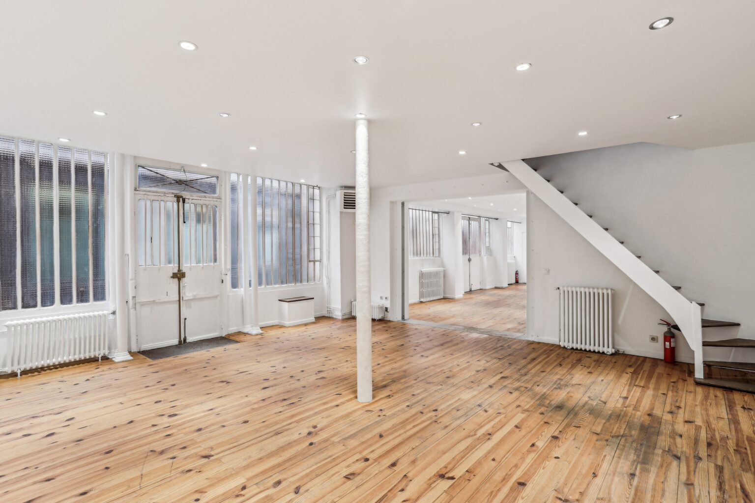 Open ground floor retail space with wood flooring.