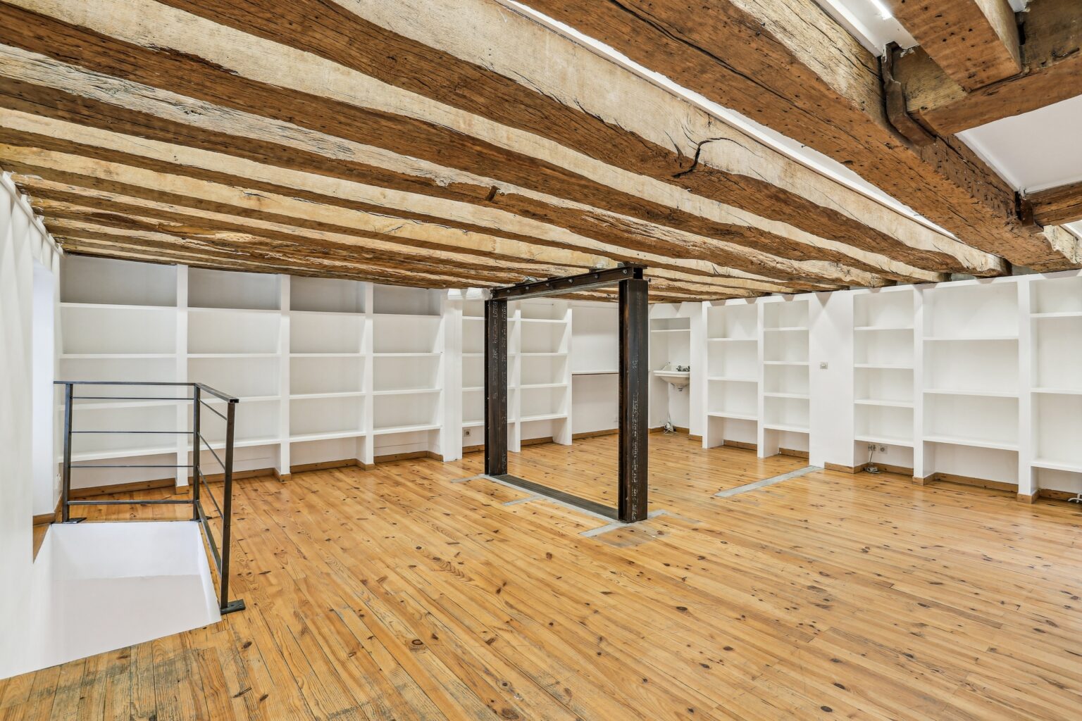 Small first floor salon with wooden flooring.