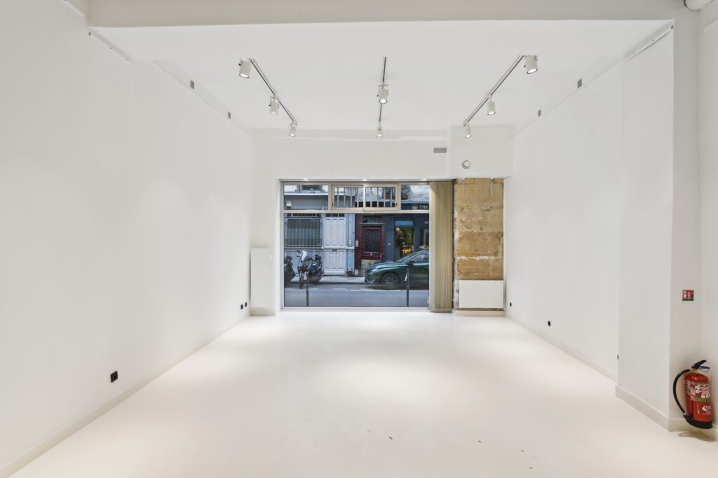 Rear showroom space facing storefront at 52 Rue Charlot