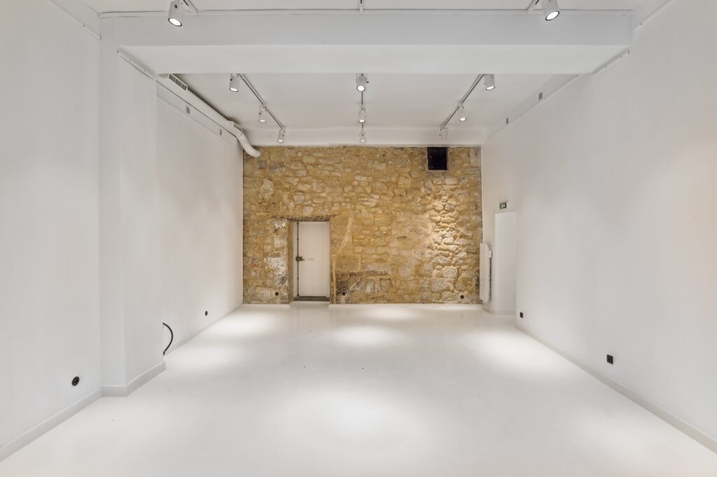 Stone wall feature inside showroom at 52 Rue Charlot