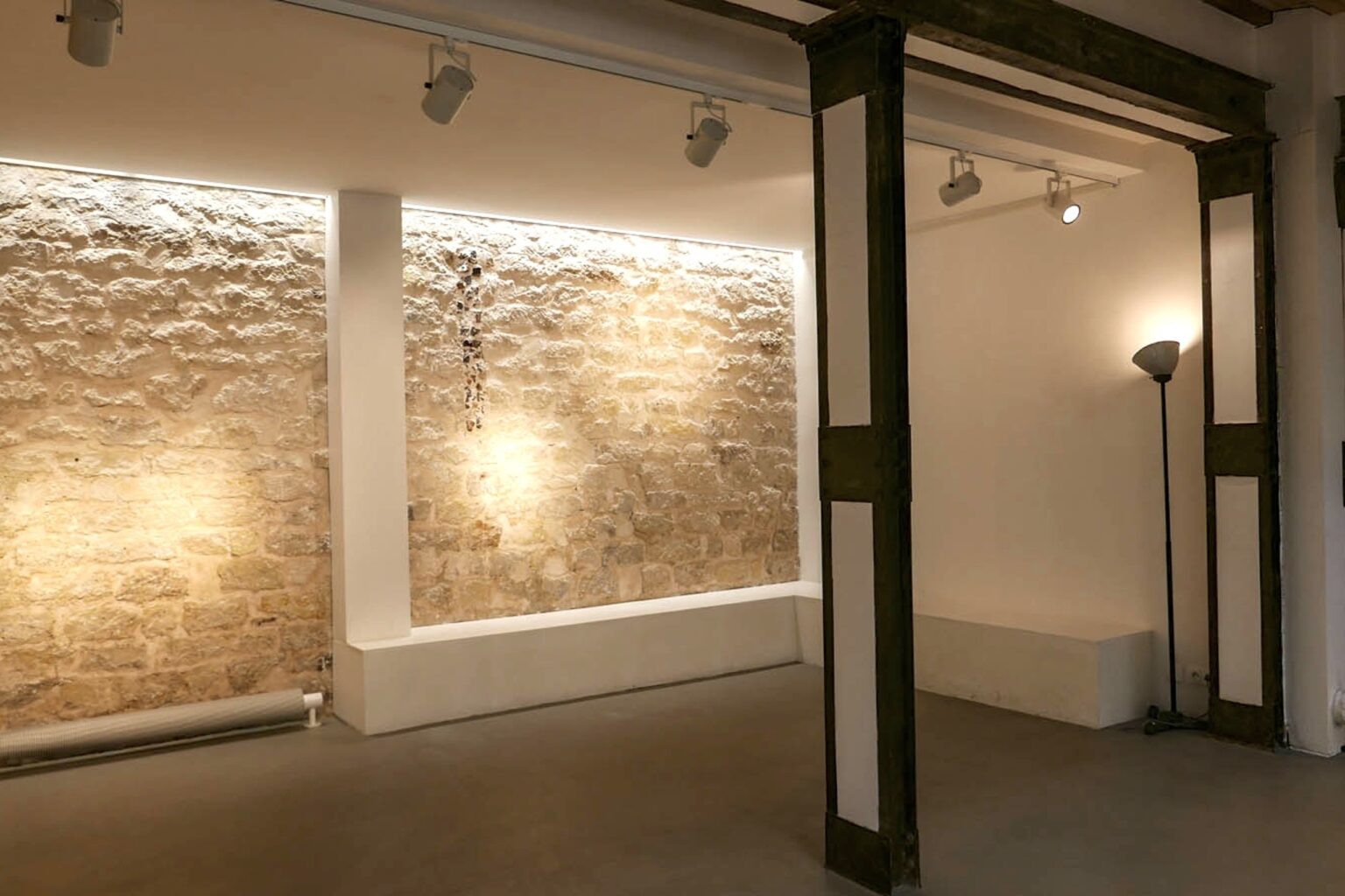 Backlit stone wall gallery showroom Paris Fashion Week