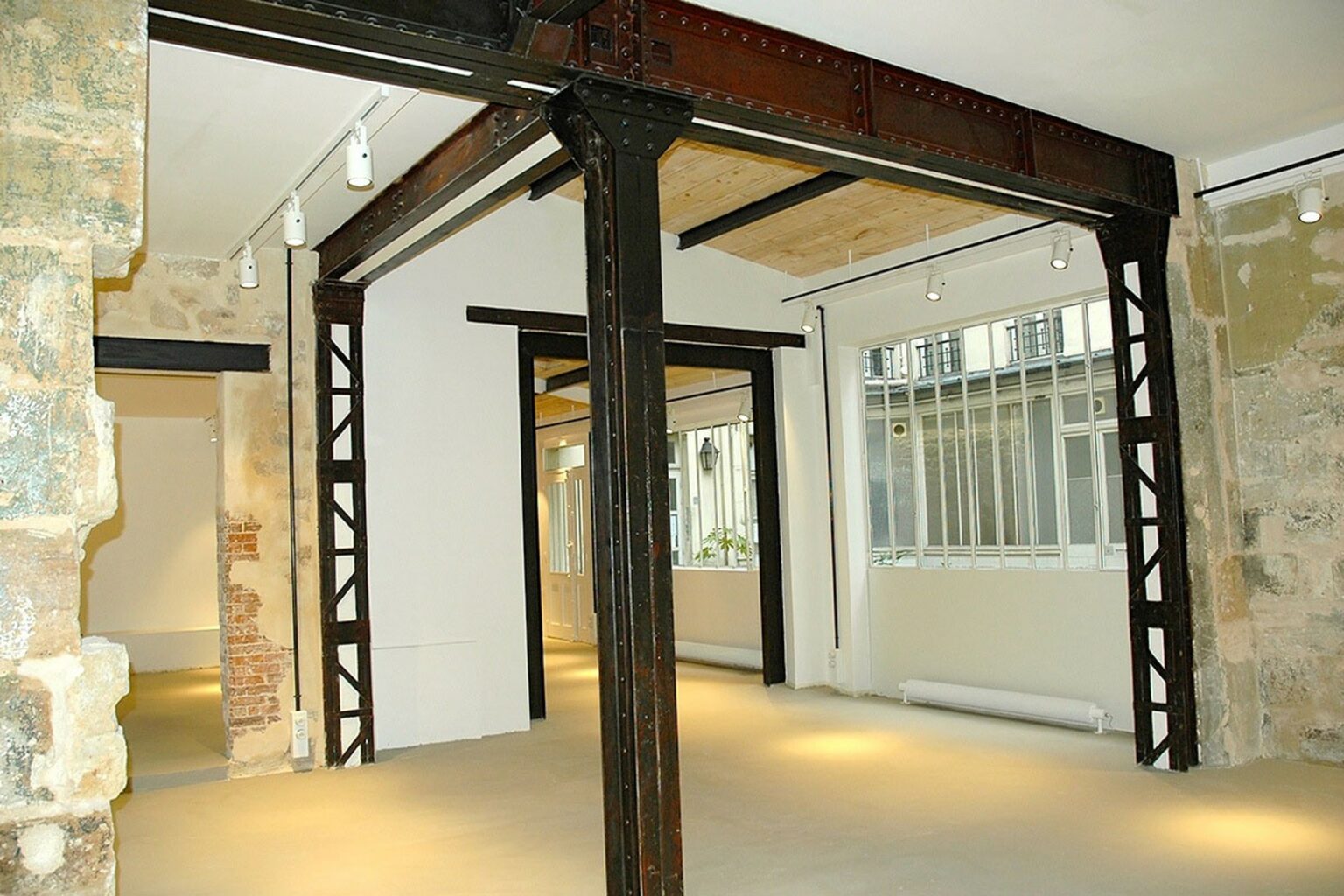 Industrial steel beam structure inside Paris Marais showroom