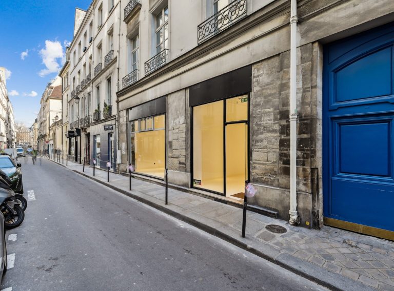 Rue Charlot streetscape with illuminated showroom — 52 Rue Charlot