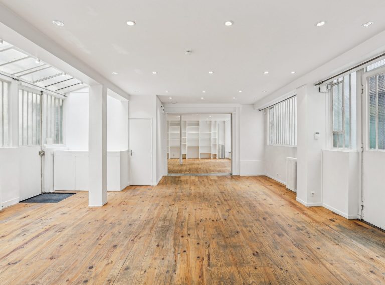 Open plan showroom with long axis and workshop glazing, Marais Paris venue