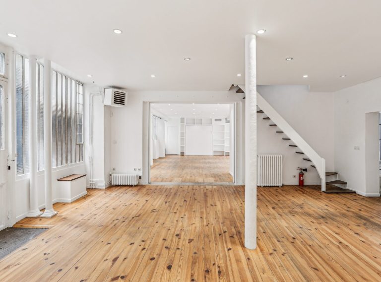 Showroom view toward stair and lounge zone, ground floor Marais venue