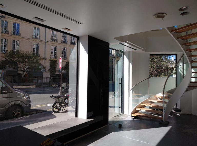 Ground-floor interior with street-facing windows and stair, 46 Rue Étienne-Marcel