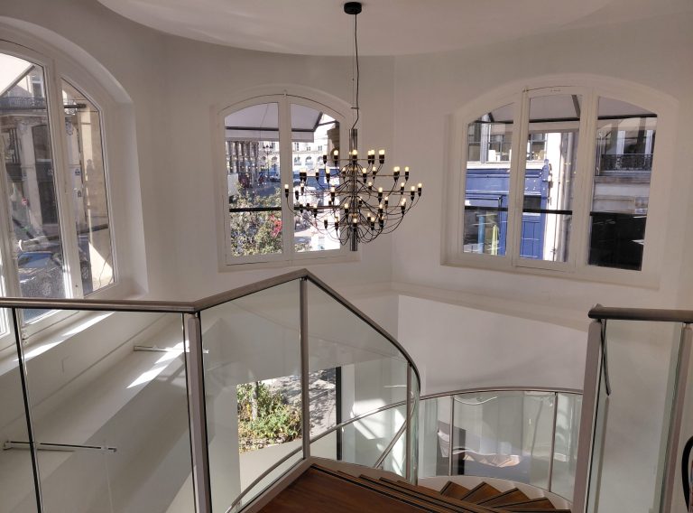 Staircase to first floor with large windows and chandelier, 46 Rue Étienne-Marcel