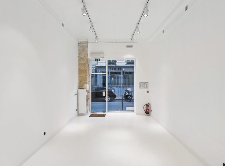 Main room facing the street showcase window — 52 Rue Charlot, Marais showroom