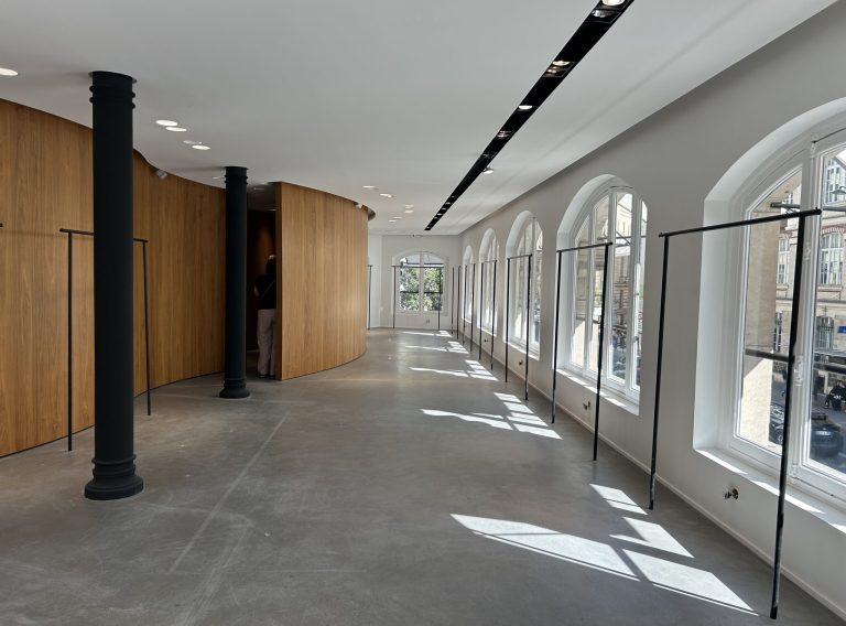 Long gallery with wood pod and opposite windows, upper floor