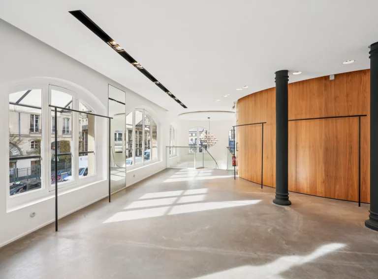 Main upper plate with windows on one side and curved wood pod on the other.