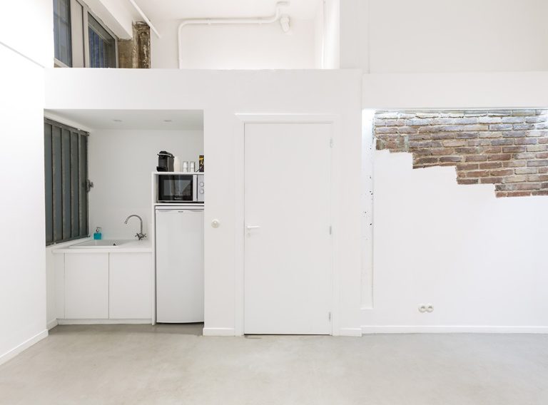 Discreet kitchenette and storage wall — Showroom Futur-Corderies