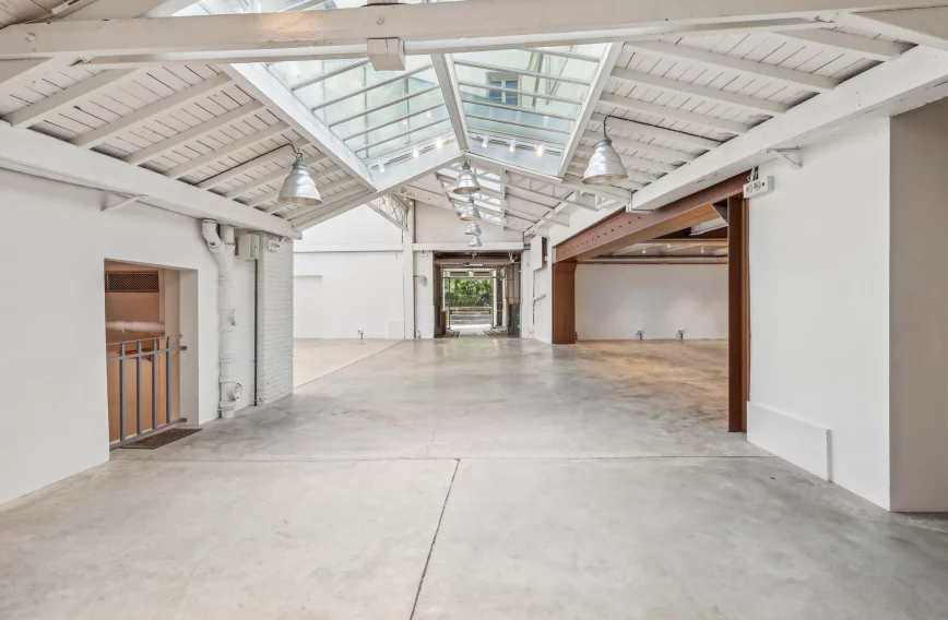 Central skylight axis leading to garden door at the far end
